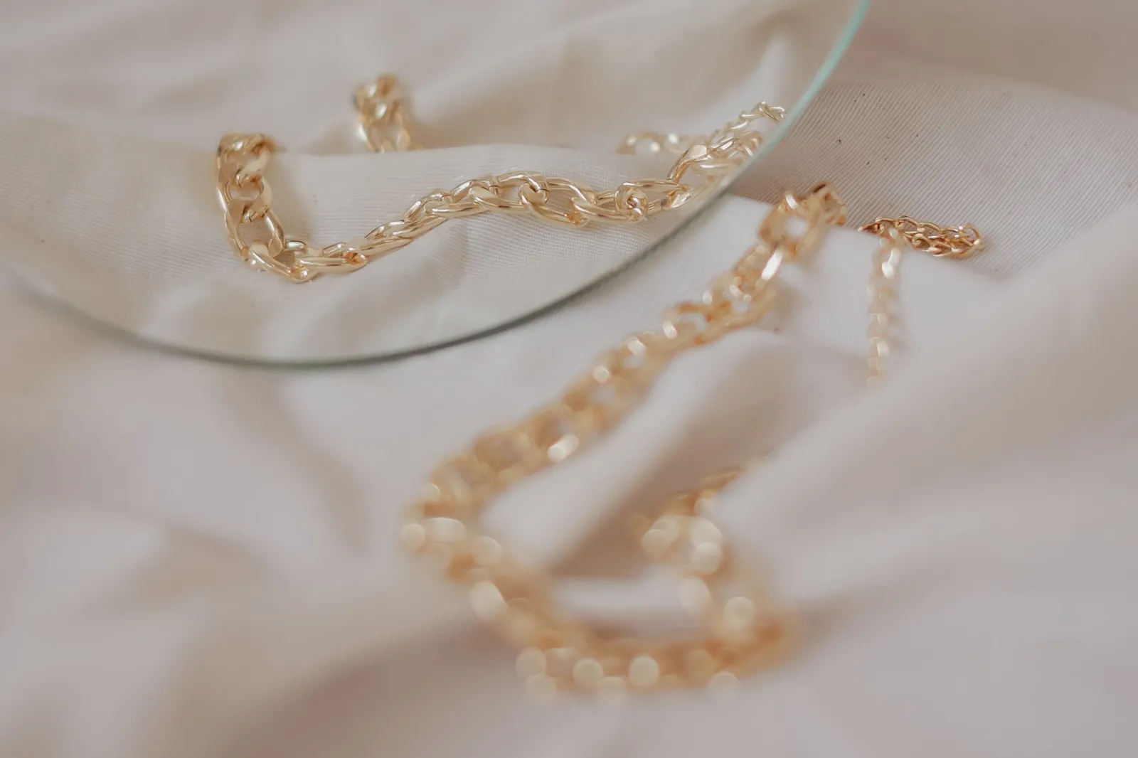 Gold chains on soft light fabric