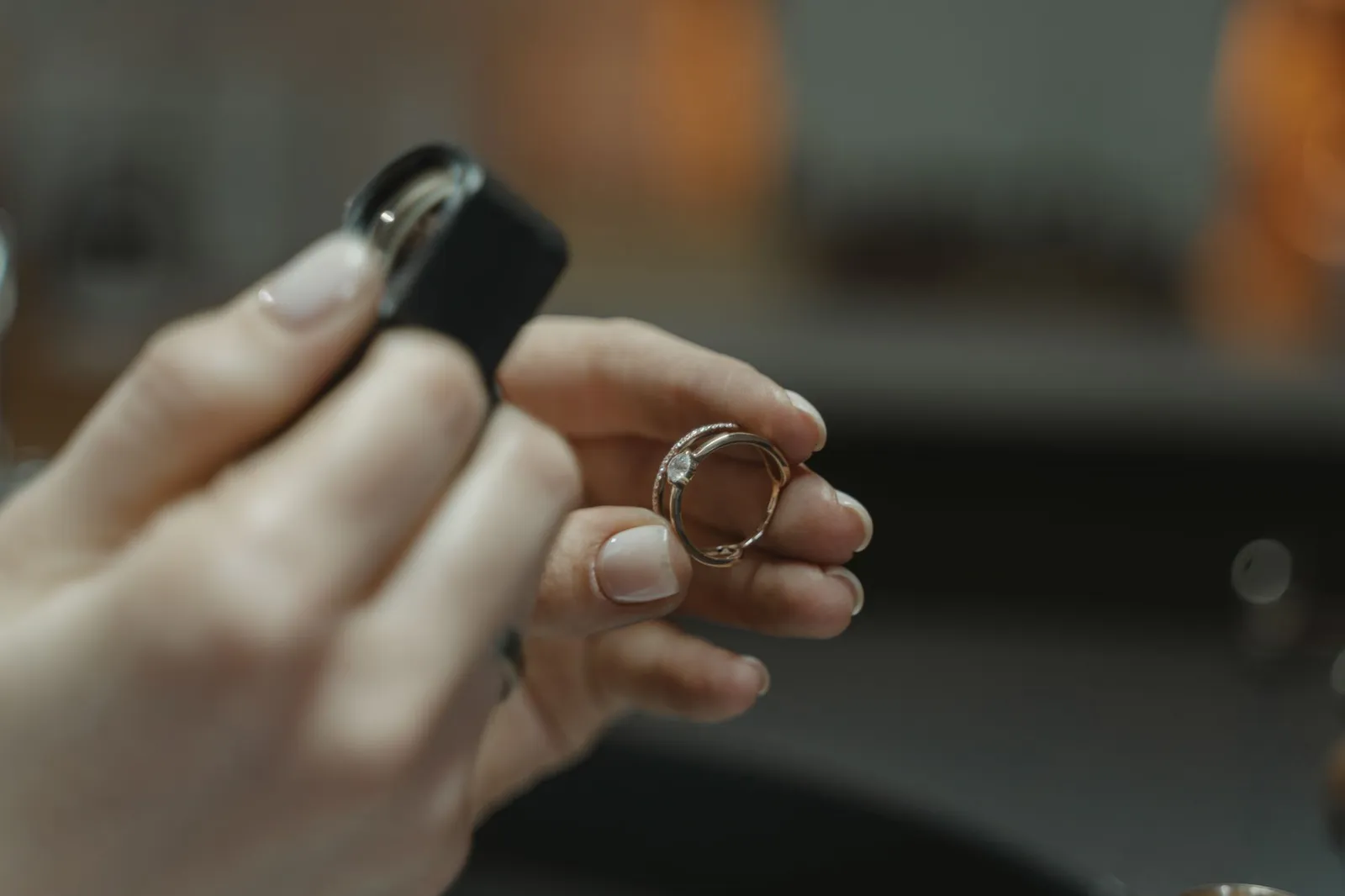 Examining a gemstone ring with a loupe