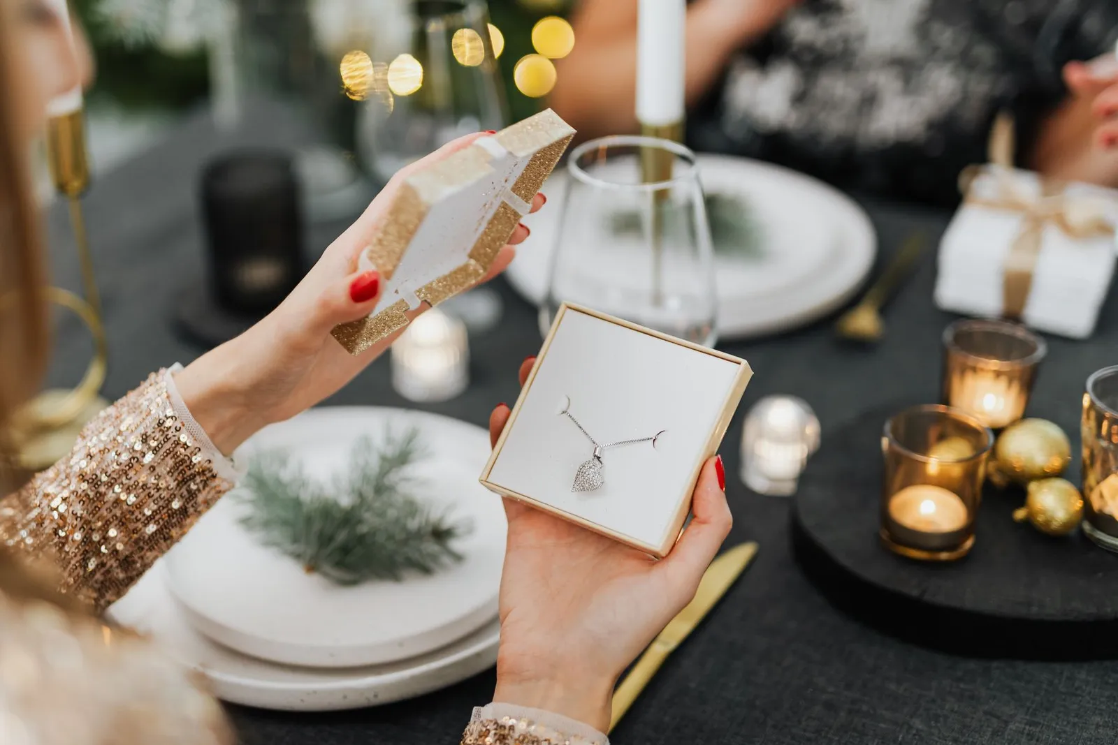 Opening a gift box with a necklace inside