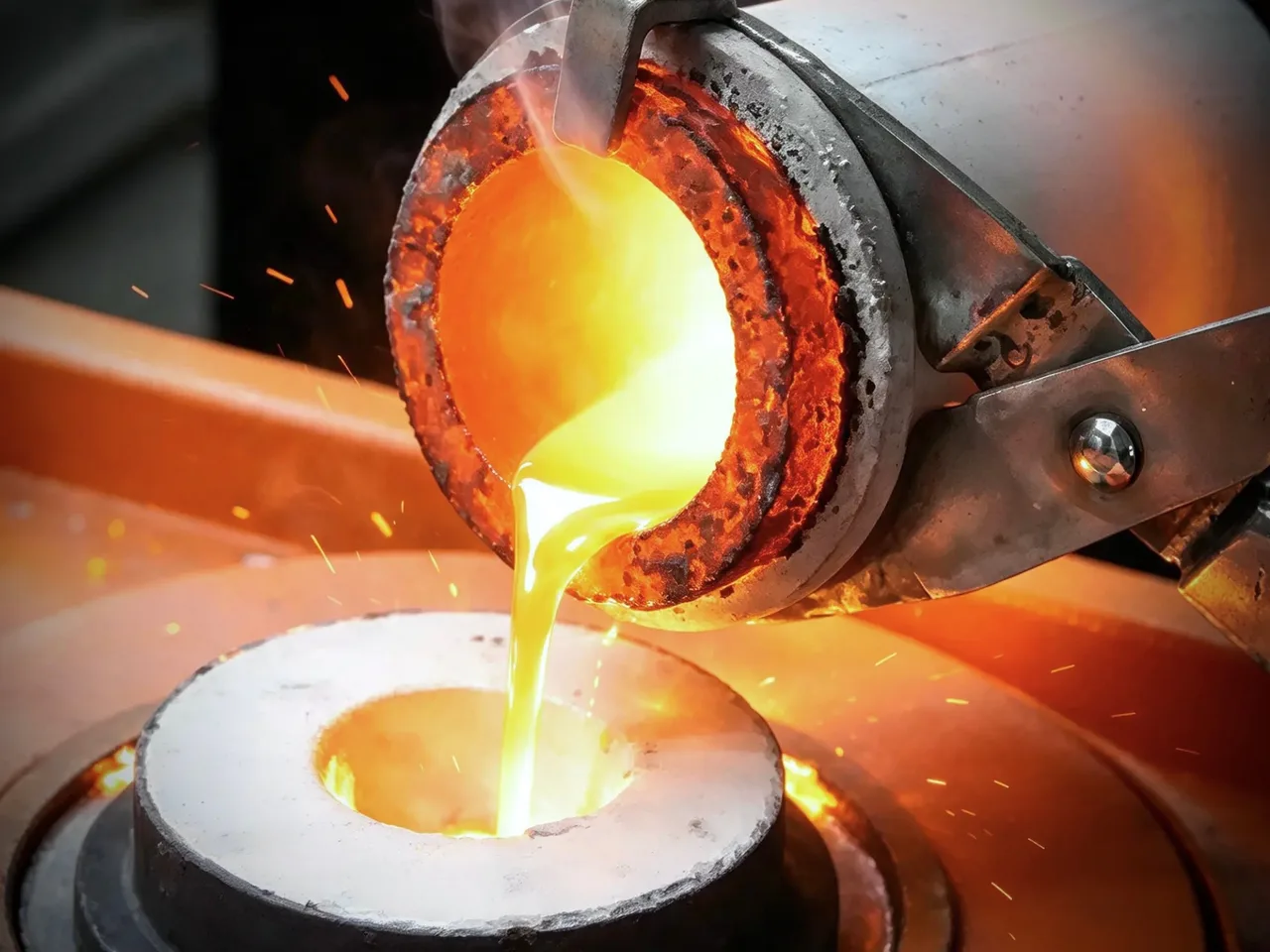 Molten gold being poured into a casting mold