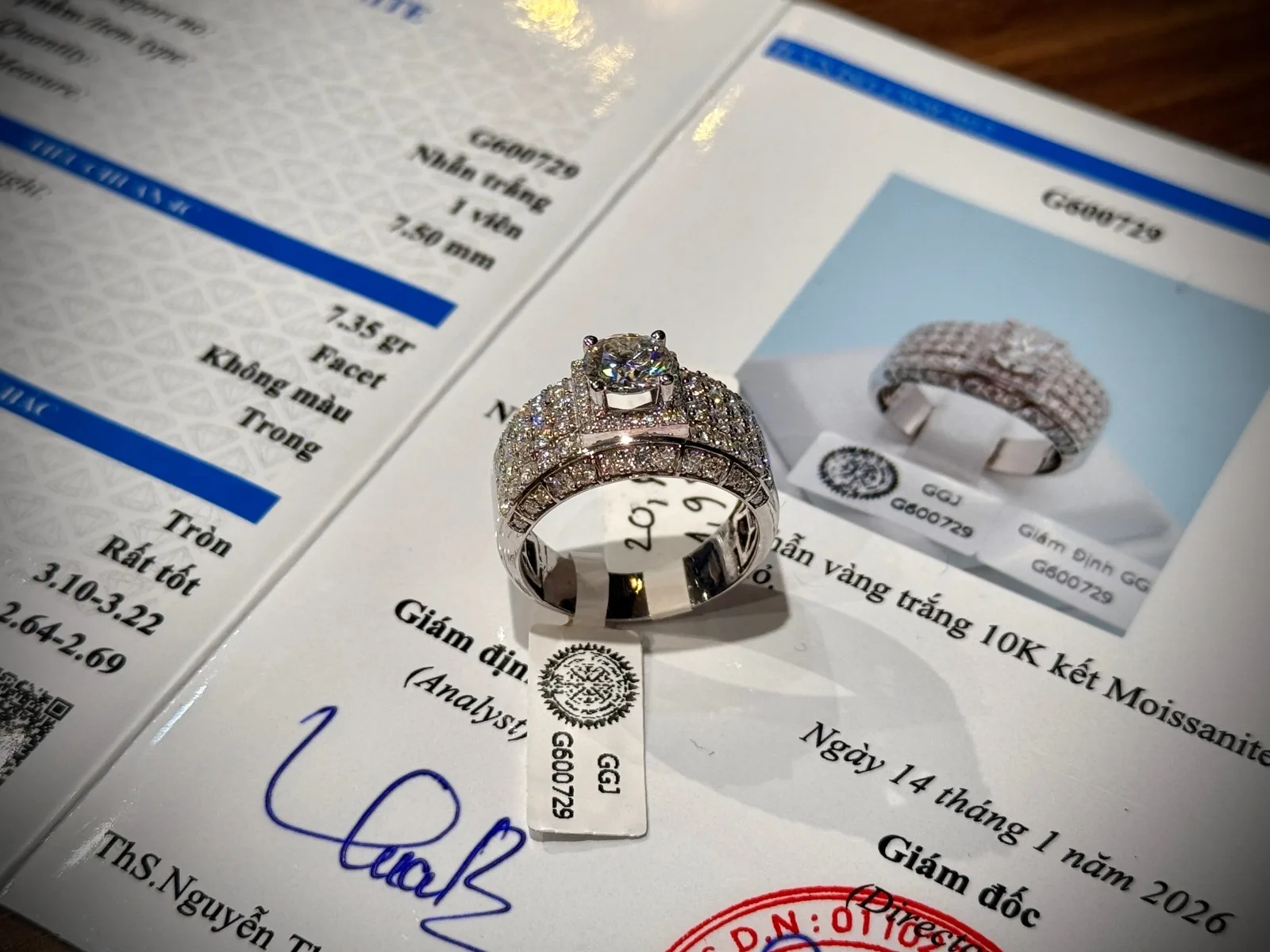 A gemstone ring resting on its certificate